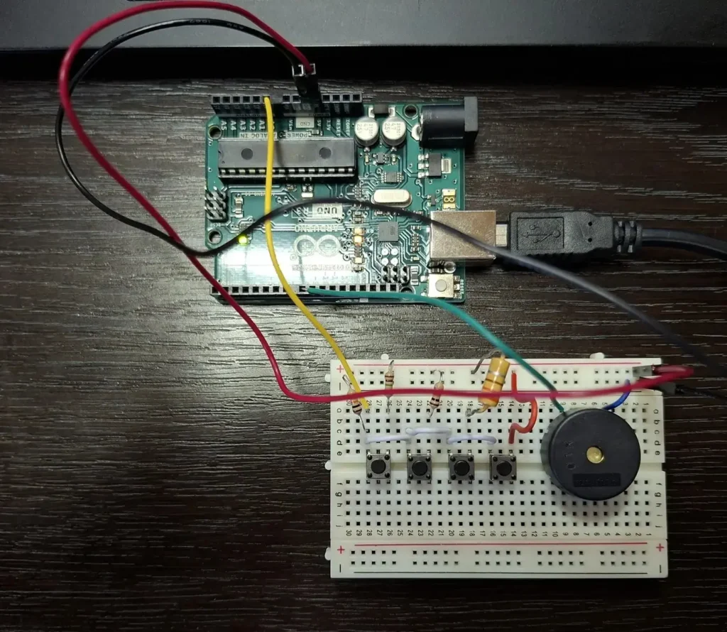 Build a simple digital keyboard that plays real notes using Arduino 3 Figure 2. Top view of the digital keyboard circuit showing the connection between Arduino Mega, push buttons, resistors, and the piezo buzzer